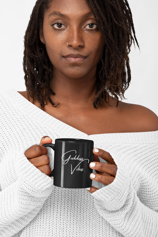 Black Girl with locs holding black mug that says Goddess Vibes in